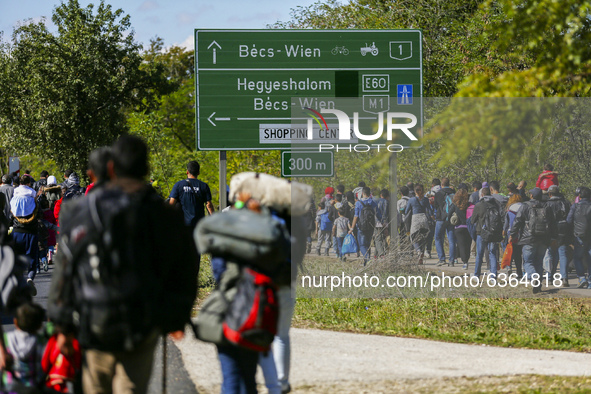 Hundreds of refugees walk to the Hungarian-Austrian border between Hegyeshalom and Nickelsdorf, after they arrived by train to Hegyeshalom,...