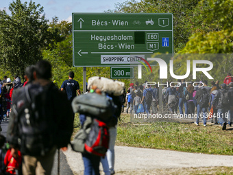 Hundreds of refugees walk to the Hungarian-Austrian border between Hegyeshalom and Nickelsdorf, after they arrived by train to Hegyeshalom,...