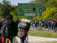 Hundreds of refugees walk to the Hungarian-Austrian border between Hegyeshalom and Nickelsdorf, after they arrived by train to Hegyeshalom,...