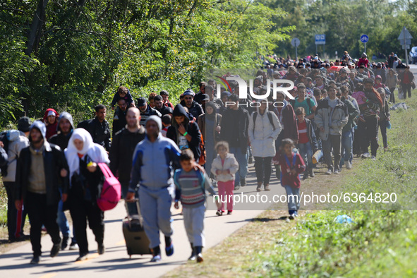 Hundreds of refugees walk to the Hungarian-Austrian border between Hegyeshalom and Nickelsdorf, after they arrived by train to Hegyeshalom,...