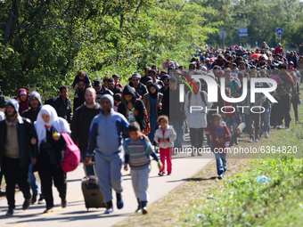 Hundreds of refugees walk to the Hungarian-Austrian border between Hegyeshalom and Nickelsdorf, after they arrived by train to Hegyeshalom,...