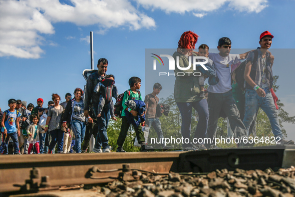 Hundreds of refugees walk to the Hungarian-Austrian border between Hegyeshalom and Nickelsdorf, after they arrived by train to Hegyeshalom,...