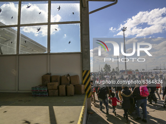 Refugees walk to the Hungarian-Austrian border between Hegyeshalom and Nickelsdorf, after they arrived by train to Hegyeshalom, Hungary on 2...