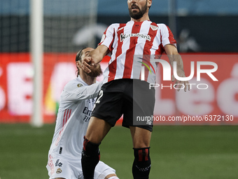 Raul Garcia of Athletic and Sergio Ramos of Real Madrid compete for the ball during the Supercopa de Espana Semi Final match between Real Ma...