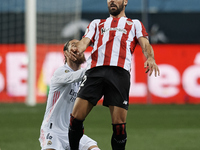 Raul Garcia of Athletic and Sergio Ramos of Real Madrid compete for the ball during the Supercopa de Espana Semi Final match between Real Ma...
