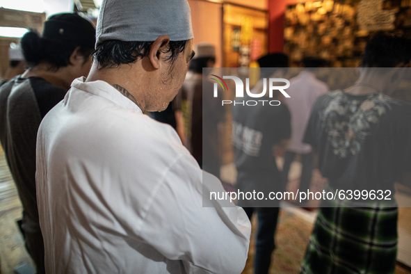 A student with his friends pray together. Islamic boarding school for punk and street children in Ruko Cimanggis, Ciputat, South Tangerang,...