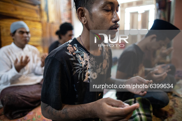 A student with his friends after pray. Islamic boarding school for punk and street children in Ruko Cimanggis, Ciputat, South Tangerang, Ban...