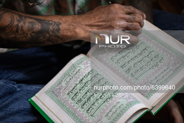 A student open quran to read after pray. Islamic boarding school for punk and street children in Ruko Cimanggis, Ciputat, South Tangerang, B...