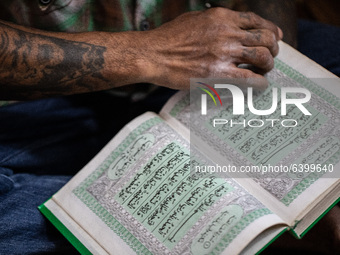 A student open quran to read after pray. Islamic boarding school for punk and street children in Ruko Cimanggis, Ciputat, South Tangerang, B...