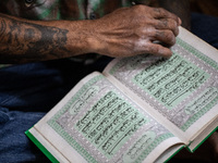 A student open quran to read after pray. Islamic boarding school for punk and street children in Ruko Cimanggis, Ciputat, South Tangerang, B...