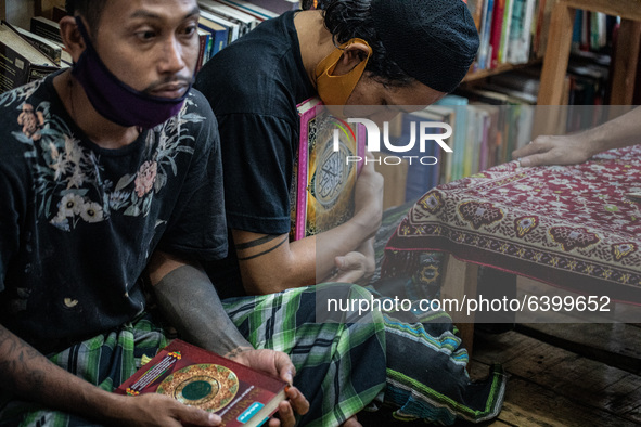 student hug his quran. Islamic boarding school for punk and street children in Ruko Cimanggis, Ciputat, South Tangerang, Banten, Indonesia,...