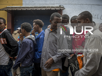 Migrants rest outside "Baobab" migration centre next to the Tiburtina train station in Rome on June 15, 2015. Hundreds of migrants mainly fr...