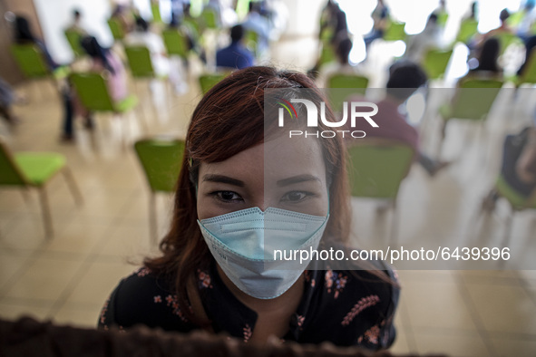  A health worker posed for a picture in waiting line for the vaccination. 2nd Phase of Vaccination covid19 for health worker in Indonesia he...