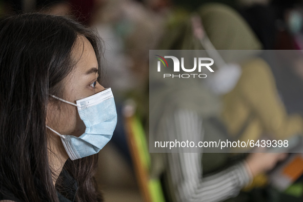 A health worker waiting for her turn for vaccination.  2nd Phase of Vaccination covid19 for health worker in Indonesia held at one of locati...