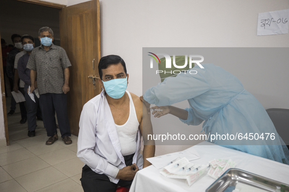 A man receives a Oxford-AstraZeneca COVID-19 vaccine manufactured by the Serum Institute of India, at National Institute of Cancer Research...