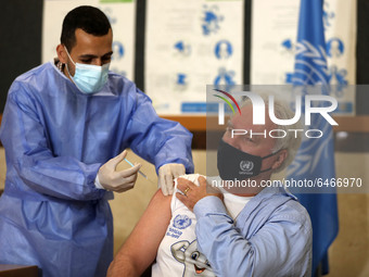 Matthias Schmale, UNRWA's Gaza director, receives a vaccine against the coronavirus disease (COVID-19) at a United Nations-run clinic in Gaz...