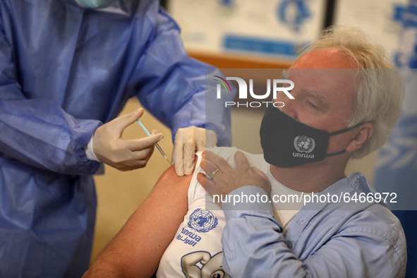 Matthias Schmale, UNRWA's Gaza director, receives a vaccine against the coronavirus disease (COVID-19) at a United Nations-run clinic in Gaz...