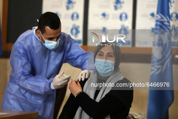 A Palestinian UNRWA employee, receives a vaccine against the coronavirus disease (COVID-19) at a United Nations-run clinic in Gaza City Febr...