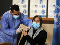 A Palestinian UNRWA employee, receives a vaccine against the coronavirus disease (COVID-19) at a United Nations-run clinic in Gaza City Febr...