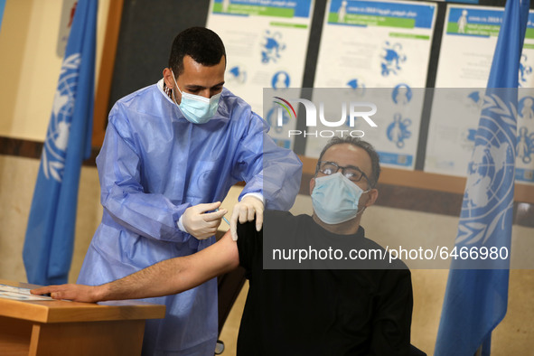 A Palestinian UNRWA employee, receives a vaccine against the coronavirus disease (COVID-19) at a United Nations-run clinic in Gaza City Febr...