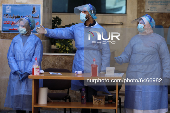 Health workers receive patients in a United Nations-run clinic amid the coronavirus disease (COVID-19) outbreak, in Gaza City February 24, 2...