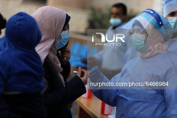 Health workers receive patients in a United Nations-run clinic amid the coronavirus disease (COVID-19) outbreak, in Gaza City February 24, 2...