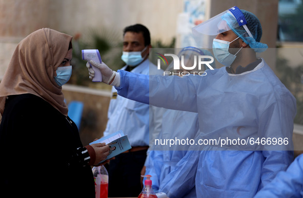 Health workers receive patients in a United Nations-run clinic amid the coronavirus disease (COVID-19) outbreak, in Gaza City February 24, 2...