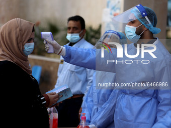 Health workers receive patients in a United Nations-run clinic amid the coronavirus disease (COVID-19) outbreak, in Gaza City February 24, 2...