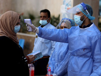 Health workers receive patients in a United Nations-run clinic amid the coronavirus disease (COVID-19) outbreak, in Gaza City February 24, 2...