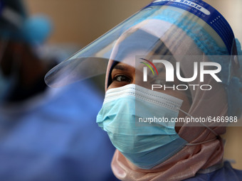 A Palestinian health worker in a United Nations-run clinic amid the coronavirus disease (COVID-19) outbreak, in Gaza City February 24, 2021....