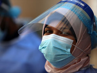 A Palestinian health worker in a United Nations-run clinic amid the coronavirus disease (COVID-19) outbreak, in Gaza City February 24, 2021....