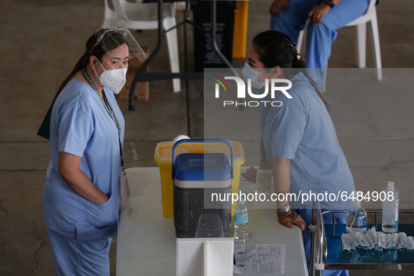 Nurses wait for hospital workers who are scheduled to receive the Sinovac COVID19 vaccine during a ceremonial vaccination program held insid...