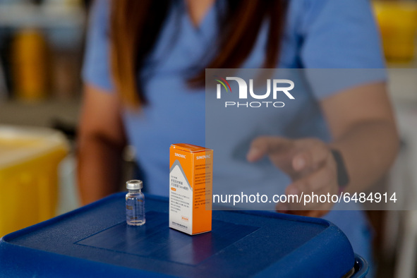 A nurse shows the Sinovac COVID19 vaccine to the media during a ceremonial vaccination program held inside a sports stadium in Marikina City...