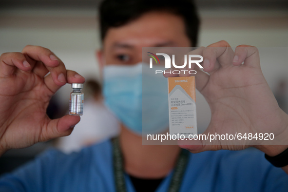 A nurse shows the Sinovac COVID19 vaccine to the media during a ceremonial vaccination program held inside a sports stadium in Marikina City...