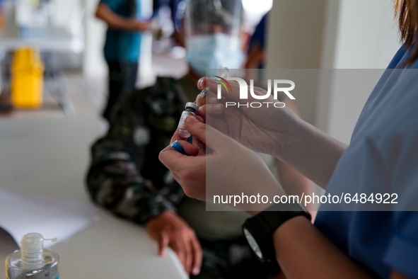 A nurse prepares to administer the Sinovac COVID19 vaccine during a ceremonial vaccination program held inside a sports stadium in Marikina...