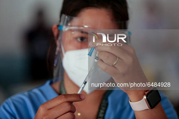 A nurse prepares to administer the Sinovac COVID19 vaccine during a ceremonial vaccination program held inside a sports stadium in Marikina...