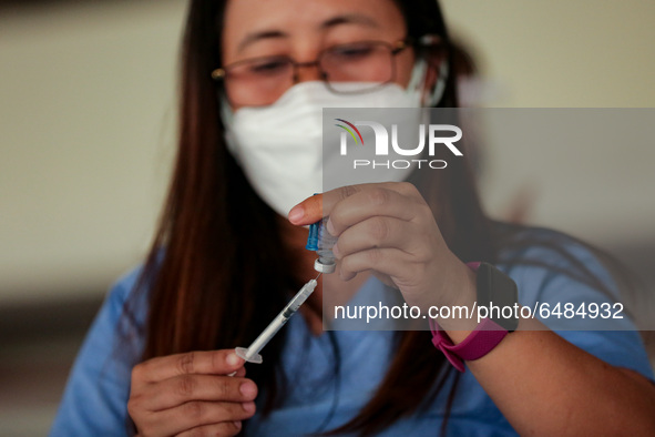 A nurse prepares to administer the Sinovac COVID19 vaccine during a ceremonial vaccination program held inside a sports stadium in Marikina...