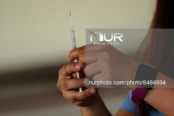 A nurse prepares to administer the Sinovac COVID19 vaccine during a ceremonial vaccination program held inside a sports stadium in Marikina...