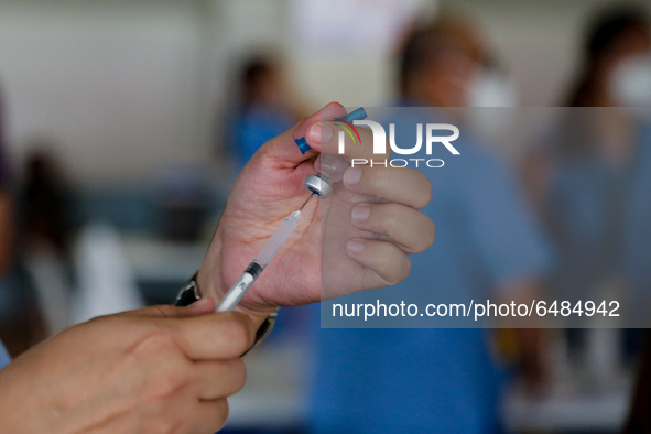 A nurse prepares to administer the Sinovac COVID19 vaccine during a ceremonial vaccination program held inside a sports stadium in Marikina...