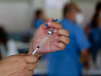 A nurse prepares to administer the Sinovac COVID19 vaccine during a ceremonial vaccination program held inside a sports stadium in Marikina...