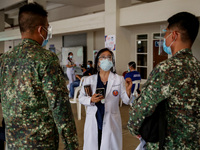 A doctor discusses the side-effects of the Sinovac COVID19 vaccine to military personnel during a ceremonial vaccination program held inside...