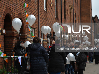 Residents of New Street in Dublin hold white balloons to say goodbye to their recently departed neighbour, Mrs. Quinn (age 89). Their homes...