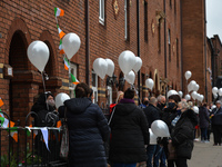 Residents of New Street in Dublin hold white balloons to say goodbye to their recently departed neighbour, Mrs. Quinn (age 89). Their homes...