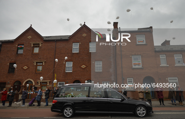 As a hearse drives by, New Street residents launch white balloons to say goodbye to Mrs. Quinn (89), their recently deceased neighbour.
Sinc...