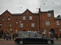 As a hearse drives by, New Street residents launch white balloons to say goodbye to Mrs. Quinn (89), their recently deceased neighbour.
Sinc...