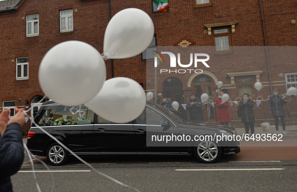 Residents of New Street in Dublin hold white balloons to say goodbye to their recently departed neighbour, Mrs. Quinn (age 89). 
Since the b...