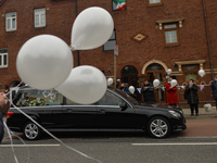 Residents of New Street in Dublin hold white balloons to say goodbye to their recently departed neighbour, Mrs. Quinn (age 89). 
Since the b...