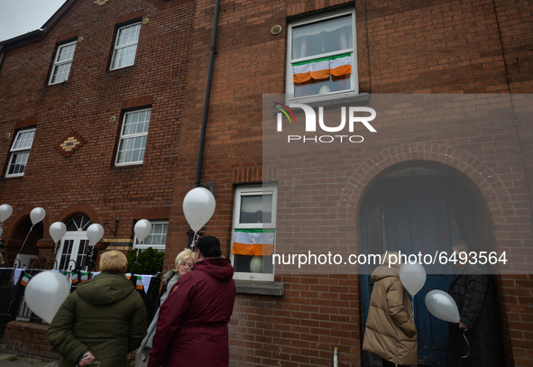 Residents of New Street in Dublin hold white balloons to say goodbye to their recently departed neighbour, Mrs. Quinn (age 89). Their homes...