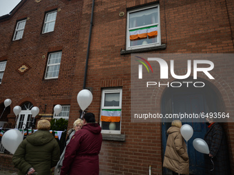 Residents of New Street in Dublin hold white balloons to say goodbye to their recently departed neighbour, Mrs. Quinn (age 89). Their homes...