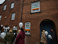 Residents of New Street in Dublin hold white balloons to say goodbye to their recently departed neighbour, Mrs. Quinn (age 89). Their homes...